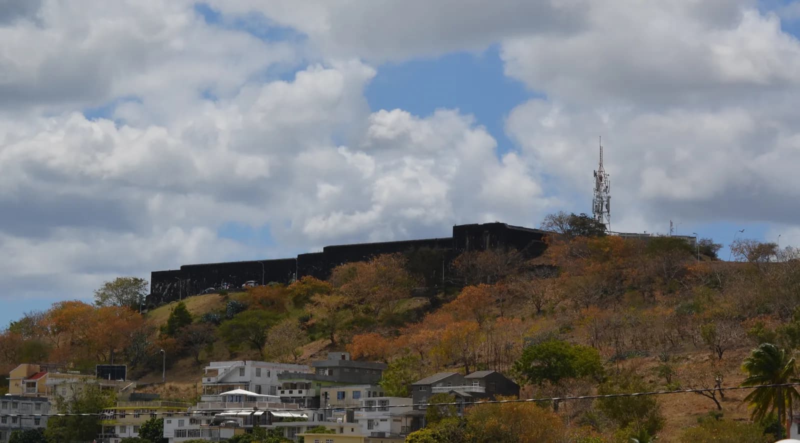 The dark stone walls of Fort Adelaide above the buildings of Port Louis