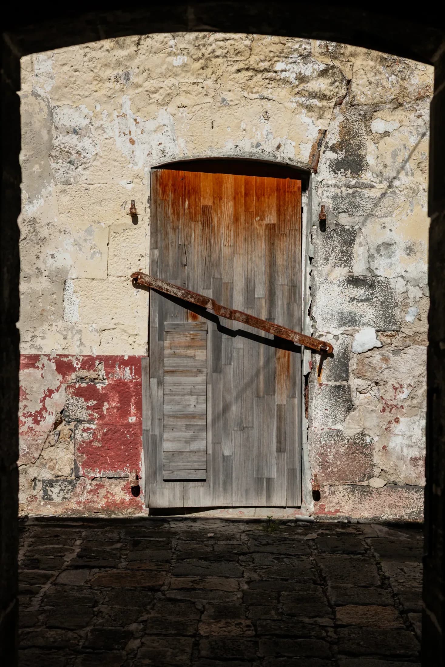 An old wooden door in a weathered stone archway, illustrating the city’s architectural heritage
